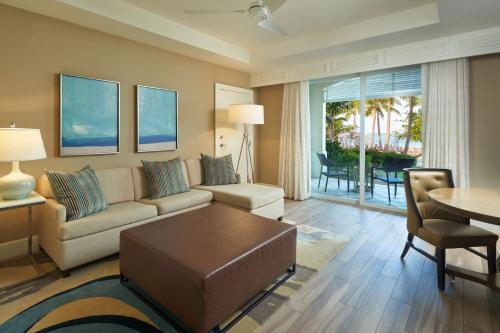 基拉戈基拉戈海滩度假酒店及Spa，傲途格精选酒店的客厅配有沙发和桌子