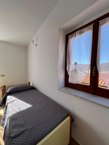 帕尔盖利亚Piccola Mansarda的一间小卧室,配有床和窗户