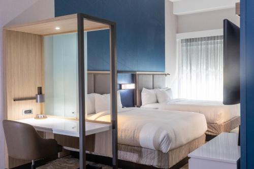 斯莱德尔SpringHill Suites by Marriott Slidell的酒店客房,设有两张床和镜子