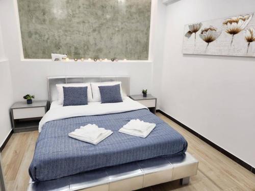 雅典Kipseli's Home的一间卧室配有一张床,上面有两条毛巾