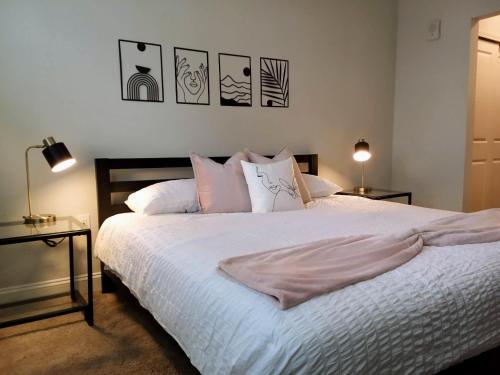 代托纳海滩"Two Bella" Luxury Apt - POOL - 4 Mi to Beach的一间卧室配有带白色床单和枕头的床。
