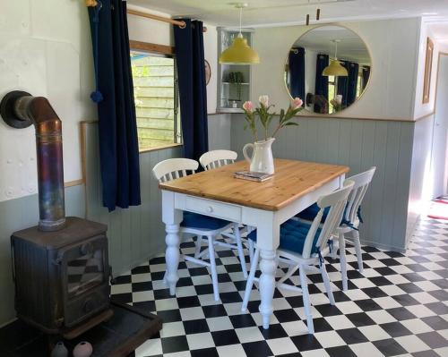 赫尔斯顿Olive's Cabin的一间带桌椅和炉灶的用餐室