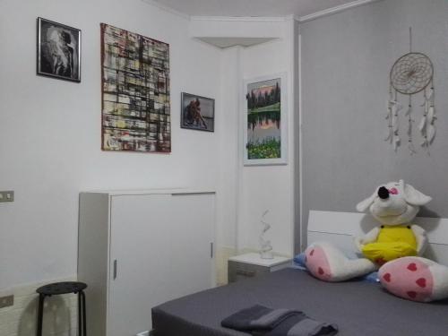 奥梅尼亚Stella的卧室配有泰迪熊,坐在床上