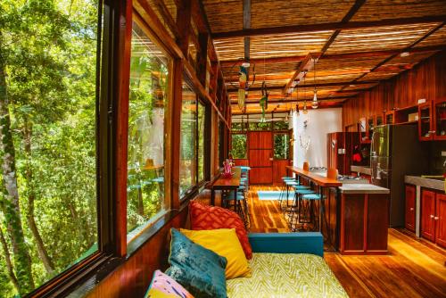 卡维塔Selva Madre Eco-Sanctuary的带沙发的客厅和带窗户的厨房