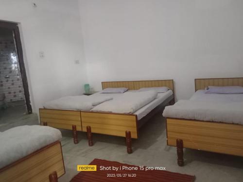 Gupta KāshiHotel Amisha的带两张单人床的带喷雾器的房间
