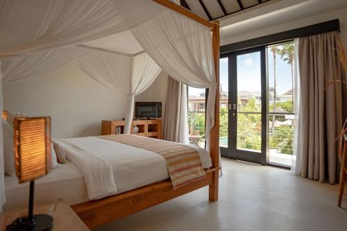 坎古Echo Beach Duo的一间卧室设有一张天蓬床和大窗户