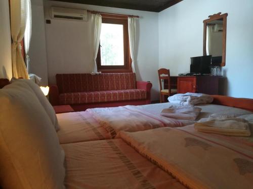 斯塔佐扎格斯基巴尼комплекс Щастливците的一间卧室设有两张床、一张沙发和一个窗口