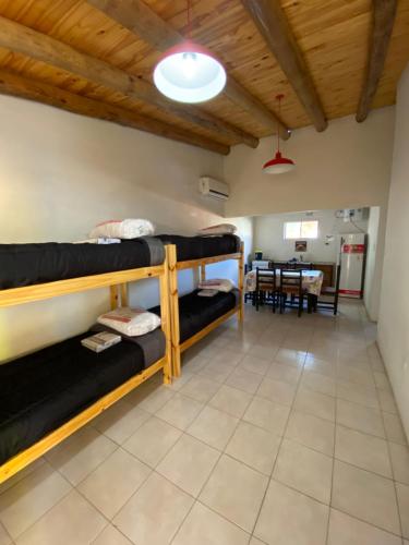 圣拉斐尔Cabañas Pausa Mendocina的客房设有三张双层床和一张桌子。