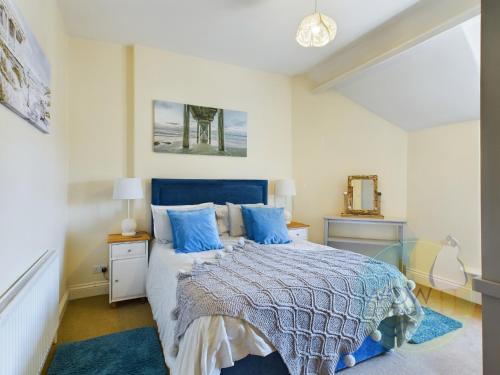 比尔Haslemere - Beer Devon的一间卧室配有蓝色的床和蓝色枕头
