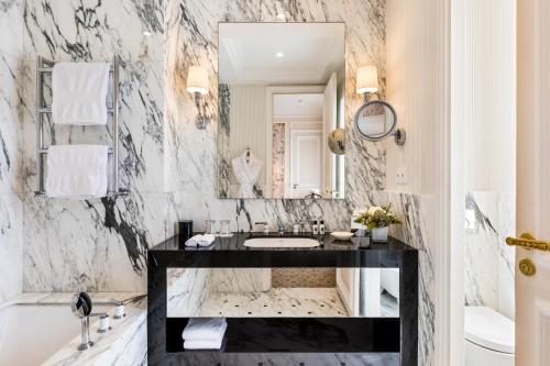 巴黎圣瑞吉斯酒店的大理石浴室配有水槽和镜子