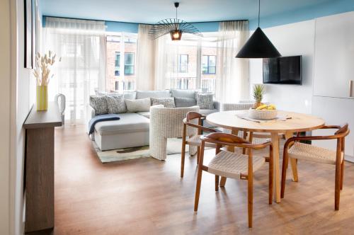 库克斯港Seehuus Duhnen Apartments的客厅配有桌子和沙发