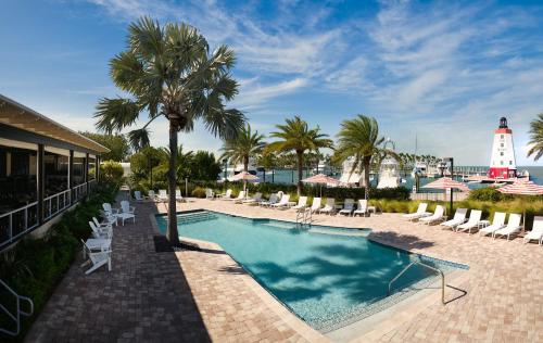 马拉松Faro Blanco Resort & Yacht Club的一个带躺椅的游泳池以及一座灯塔