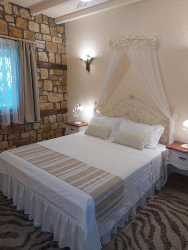 GalíniThe Stone Heaven的卧室配有白色的砖墙床