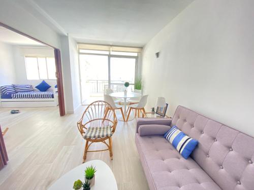 佩尼斯科拉NUEVO !!! Apartamento Peñíscola Playa con piscinas y tenis的客厅配有紫色沙发和桌子