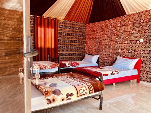 瓦迪拉姆Salameh's Bedouin Camp的帐篷内带三张床的房间
