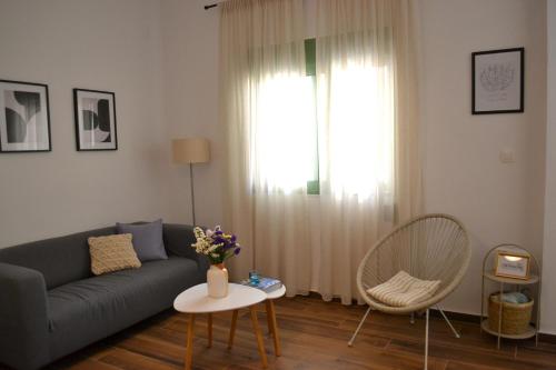 爱琴娜岛Yannis Guest House的带沙发、桌子和窗户的客厅