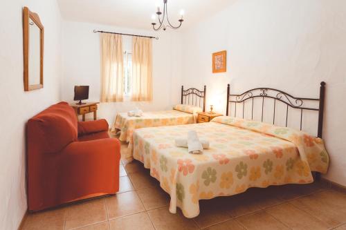科尼尔-德拉弗龙特拉Villa la Dehesa的酒店客房,配有两张床和椅子