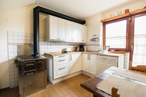 博维茨Apartma Lojz的厨房配有白色橱柜和炉灶。