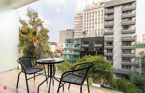 墨西哥城Casa Alure by Kukun的市景阳台配有桌椅