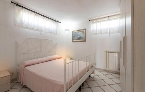 Santa LiberataLovely Home In Porto S,stefano With Wifi的白色卧室配有一张带粉色毯子的床