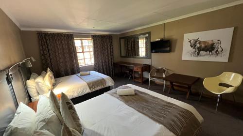 哈里史密斯Mountainview Inn的酒店客房配有两张床和一张书桌