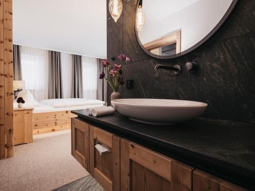 Sankt Lorenzen im LesachtalAlmwellness-Resort Tuffbad的一间带水槽和镜子的浴室