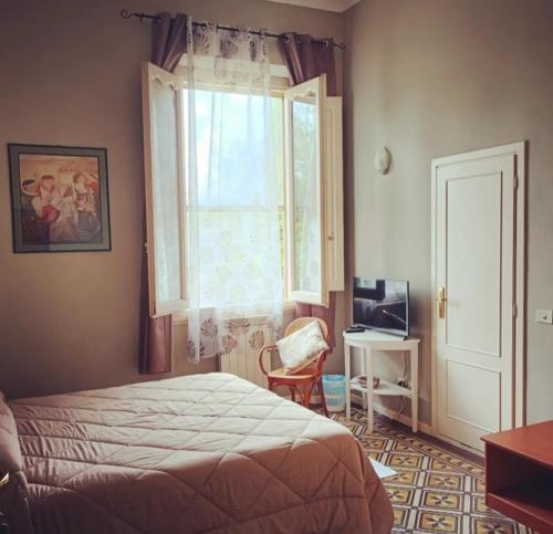 拉斯特拉阿西尼亚艾尔钢琴别墅酒店的一间卧室设有一张床、一个窗口和一把椅子