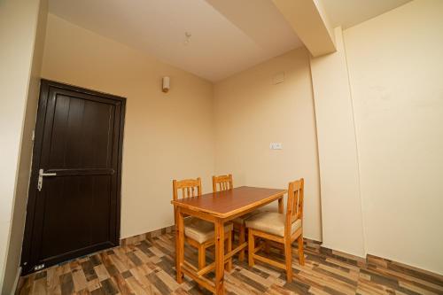 博卡拉Subedi Apartment的一间带桌椅和门的用餐室
