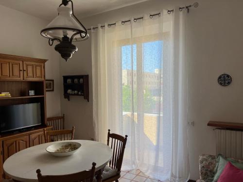 瓦达Casa Vanni的客房设有桌子和带桌椅的窗户。