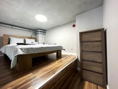 弗罗茨瓦夫Zarembowicza A38 Apartment - Self Check-In 20h - Parking &Lift的一间卧室配有一张床,铺有木地板