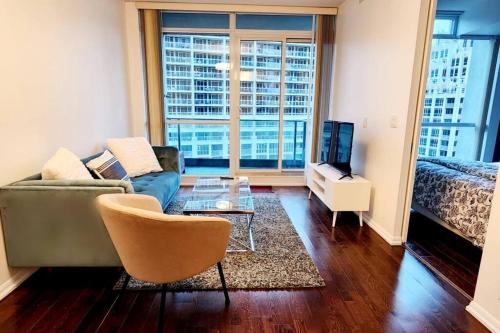 多伦多Lakeview Condo in Downtown with Free Parking.的客厅配有沙发、桌子和床。