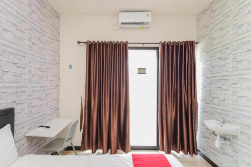 贝克西RedDoorz Syariah near Green Park Jatiwarna的一间卧室配有床、水槽和窗户