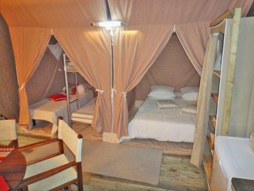 米尼赞海滩米米藏度假村海滩的帐篷内一间卧室,配有一张床