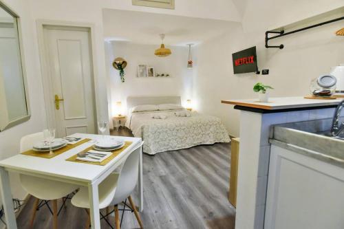 瓦里格提Welcome Varigotti - Borgo Saraceno - Tramontana的一间卧室配有一张床铺和一张桌子,还设有一间厨房