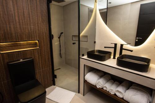 拉巴特Le M Hôtel的一间带两个盥洗盆和淋浴的浴室