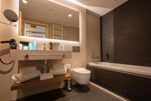 安道尔城Yomo Centric的浴室配有卫生间、盥洗盆和浴缸。