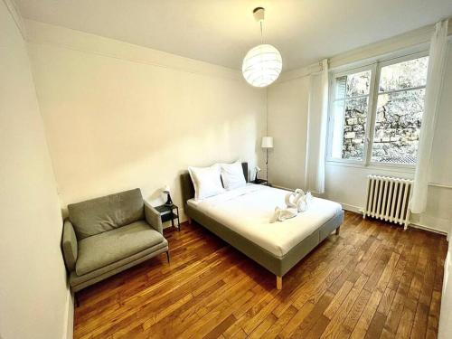 巴黎Lovely appartment - Buttes Chaumont-ParisZenith的一间卧室配有一张床、一张沙发和一个窗口