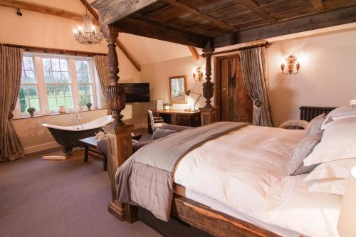 谢普顿马利特Montigo Resorts, Somerset的一间卧室设有一张大床和一个浴缸