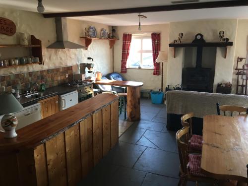 Kate’s Cottage的厨房配有柜台和桌子
