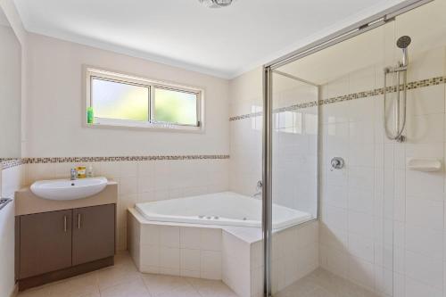 卡尔斯45 Norman Drive的带浴缸、水槽和淋浴的浴室