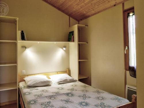 Gîte Les Noes, 3 pièces, 4 personnes - FR-1-496-246的一间卧室配有一张带两个枕头的床