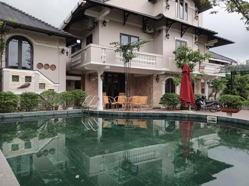 Thôn Dương Xuân HạIRIS HILL VILLA的房屋前有游泳池的房子