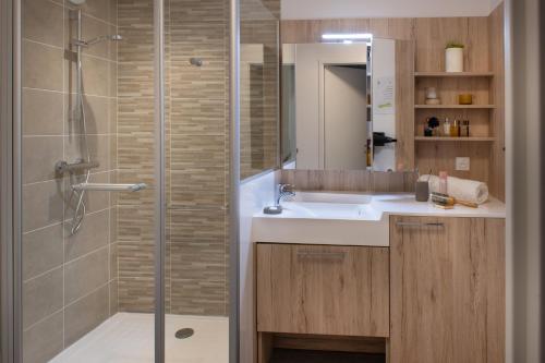阿兹布鲁克DOMITYS LES CERNEAUX的带淋浴、盥洗盆和镜子的浴室