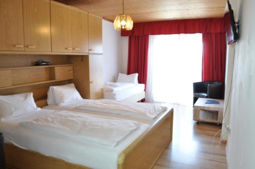 滨湖波德斯多夫Gästehaus Herlinde的一间卧室设有两张床和窗户。