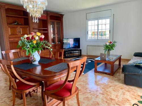 比利亚努埃瓦-赫尔特鲁Villa Felicidad的客厅设有餐桌,上面摆放着鲜花
