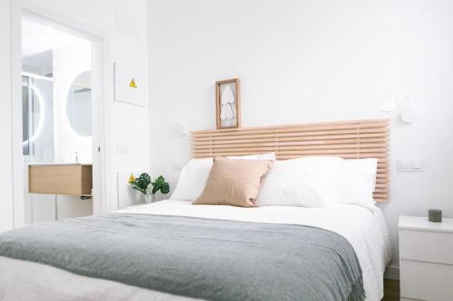马德里Acogedor y conveniente piso reformado en Salamanca的一间卧室配有一张大床和木制床头板