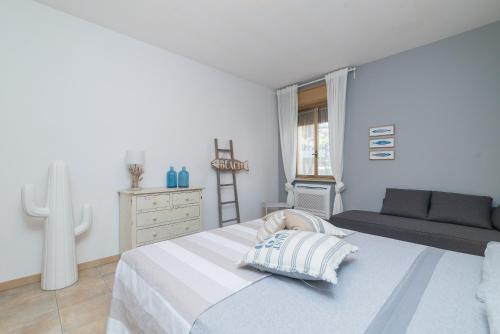 圣特雷莎加卢拉Loriana seaside home的一间白色卧室,配有一张床和一个梳妆台