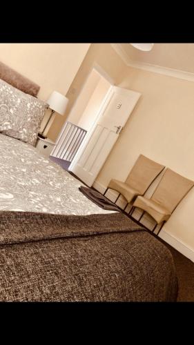 罗奇福德Ac lounge36 (B)的一间卧室配有床,一扇门配有毛巾
