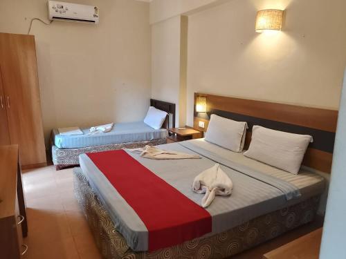 坎多林Sea Breeze Beach Resort Candolim, Goa的一间酒店客房,配有一张带毛巾的床