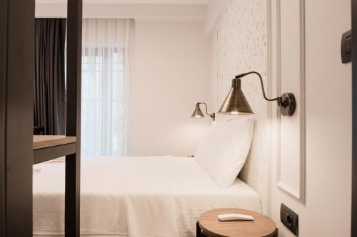 伊斯坦布尔Persona Hotel Galata的酒店客房,配有带灯和窗户的床